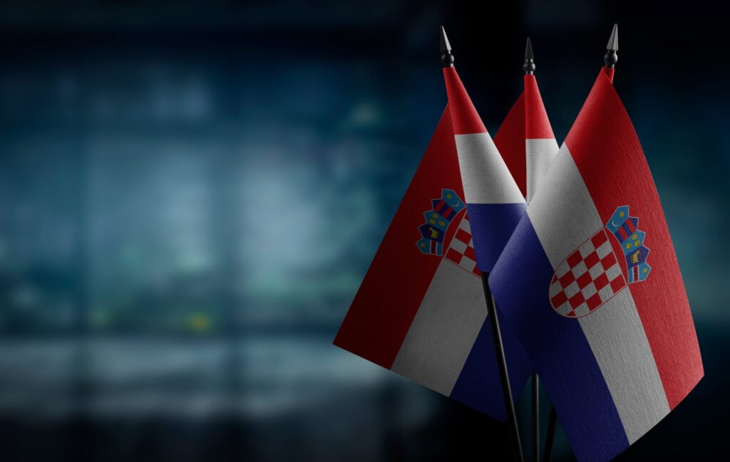 Small,Flags,Of,The,Croatia,On,An,Abstract,Blurry,Background.