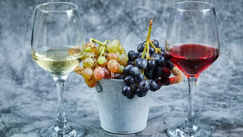 bucket-grapes-glasses-wine-marble-background-1-e1766087596821