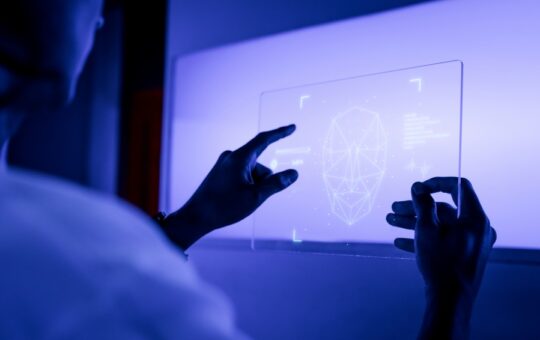 designer-using-transparent-digital-tablet-screen-futuristic-technology-599x900-1